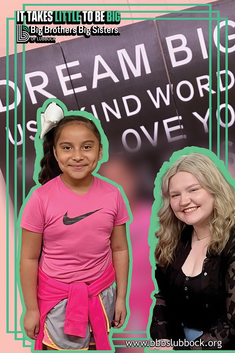 Little and Big in front of sign that reads Dream Big